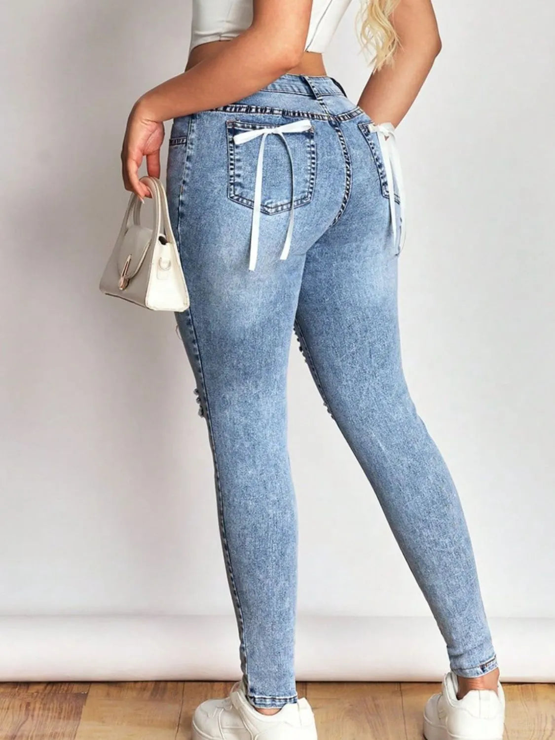 Bow Back Distressed Skinny Jeans