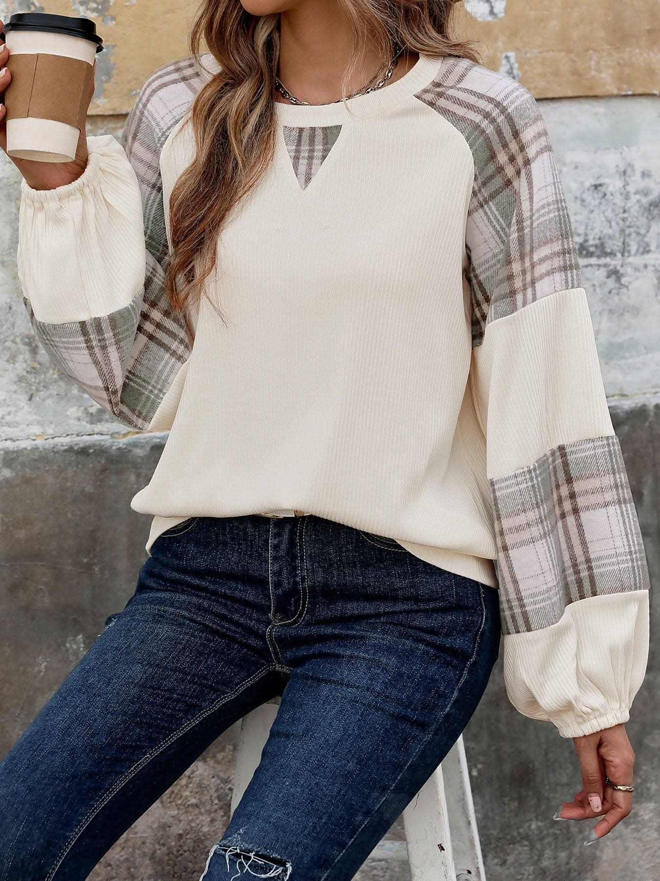 Plaid long sleeve sweatshirt with beige ribbed knit and plaid pattern on sleeves.