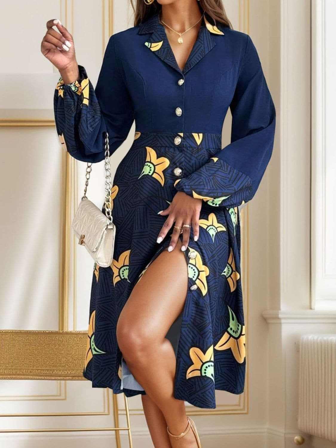Chic collared long sleeve dress with buttoned front, colorful floral pattern, and side slit.