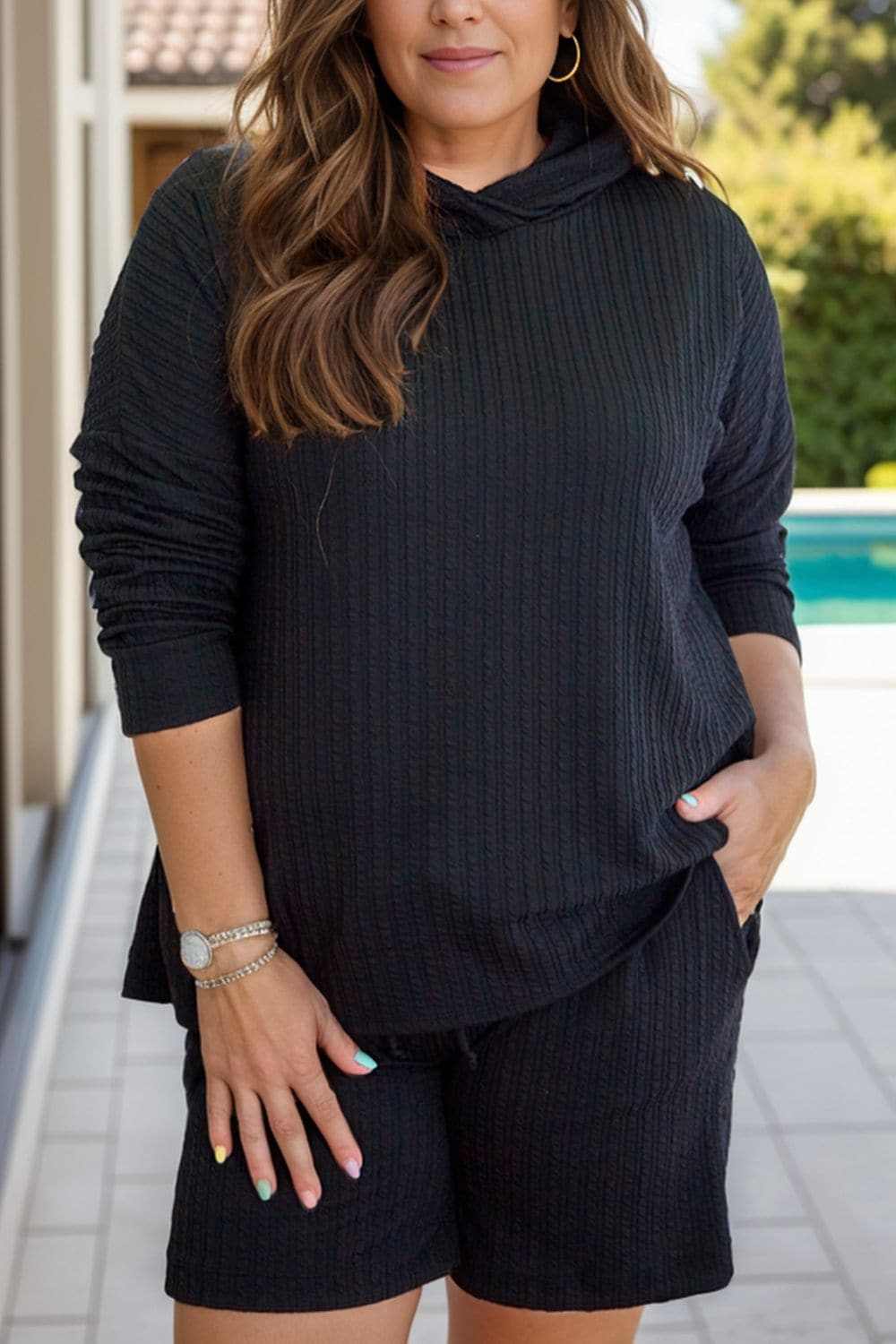 Plus size cozy hoodie and shorts set with adjustable drawstring and stretchy fabric.