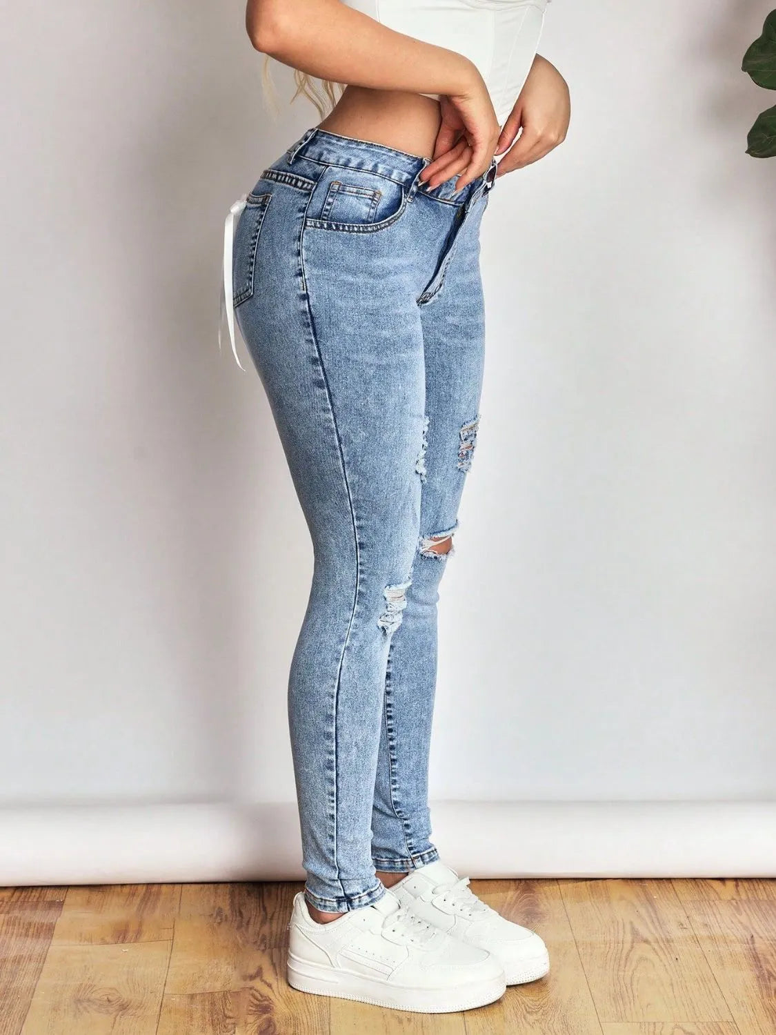 Bow Back Distressed Skinny Jeans
