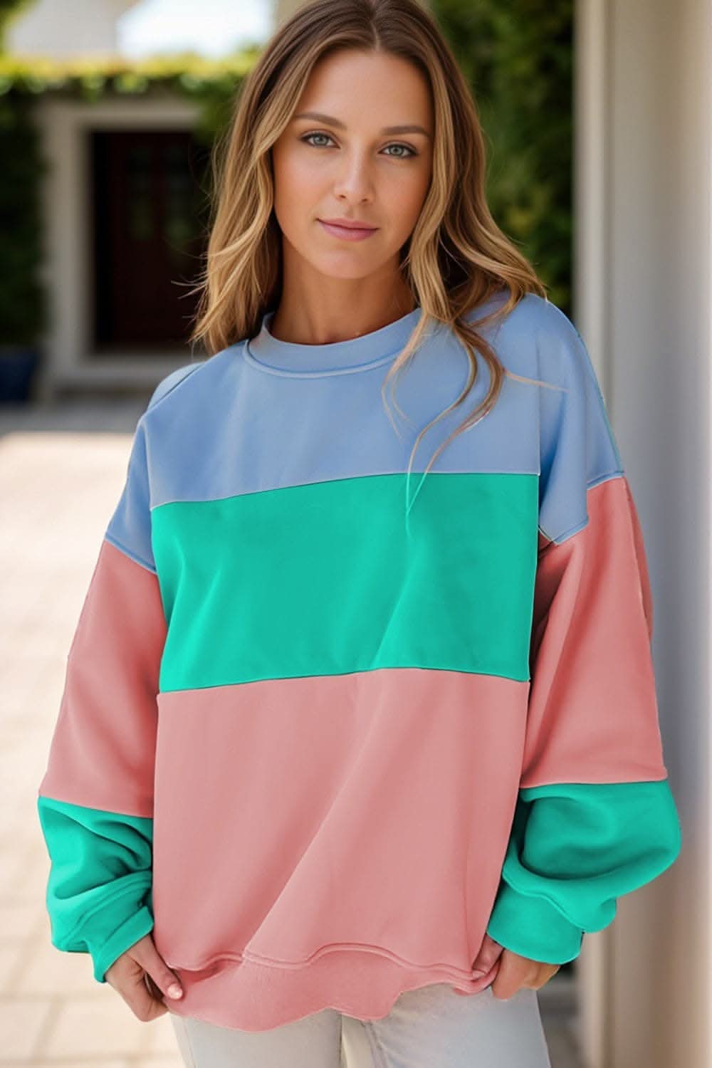 Color block round neck long sleeve sweatshirt in pastel shades worn by female model.