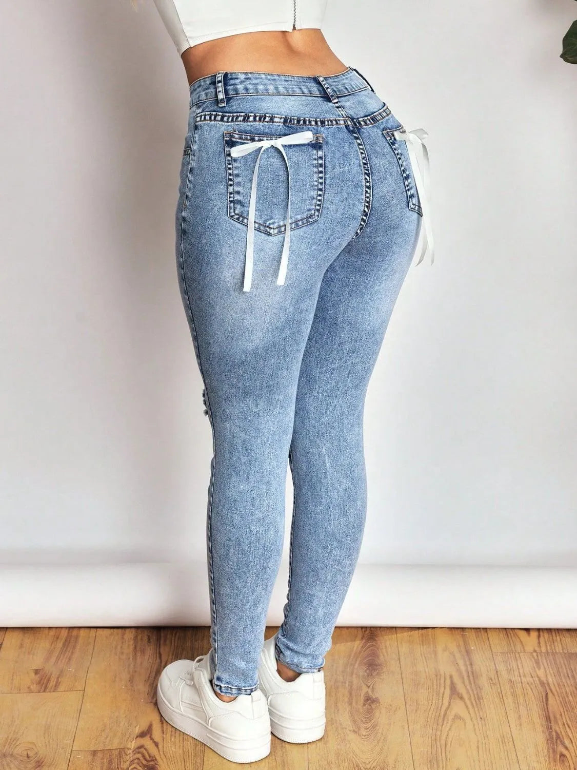 Bow Back Distressed Skinny Jeans