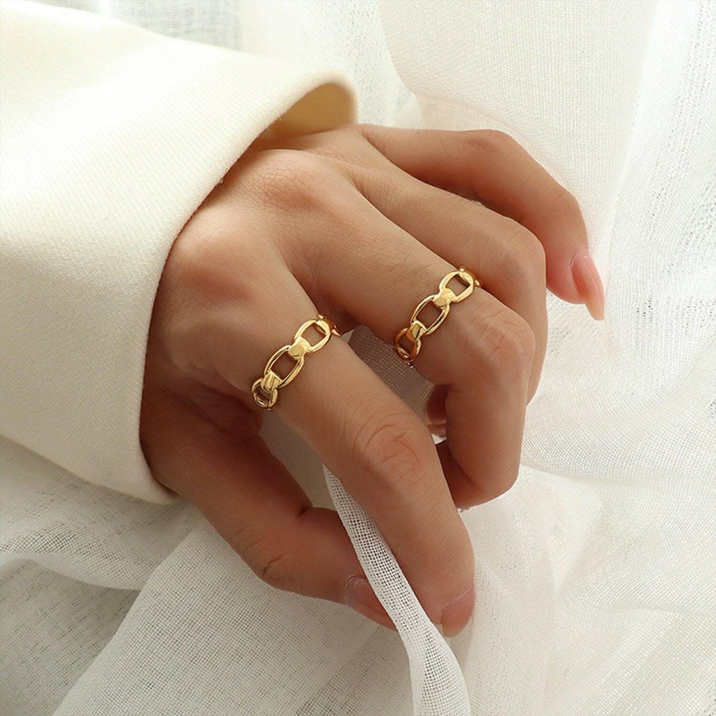 Gold-plated adjustable titanium ring on hand
