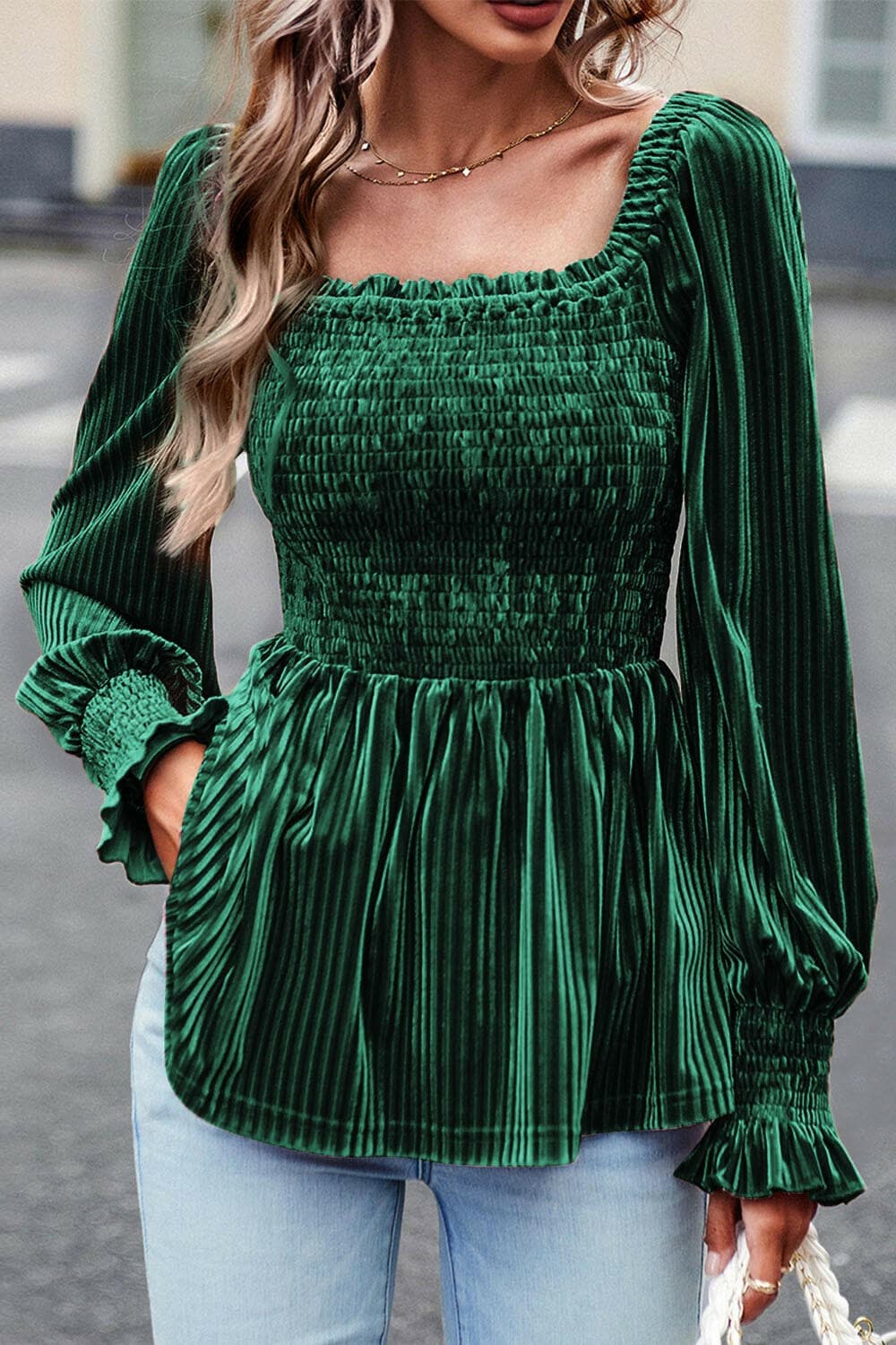 Smocked velvet babydoll top in green with chic smocked detailing and long sleeves.