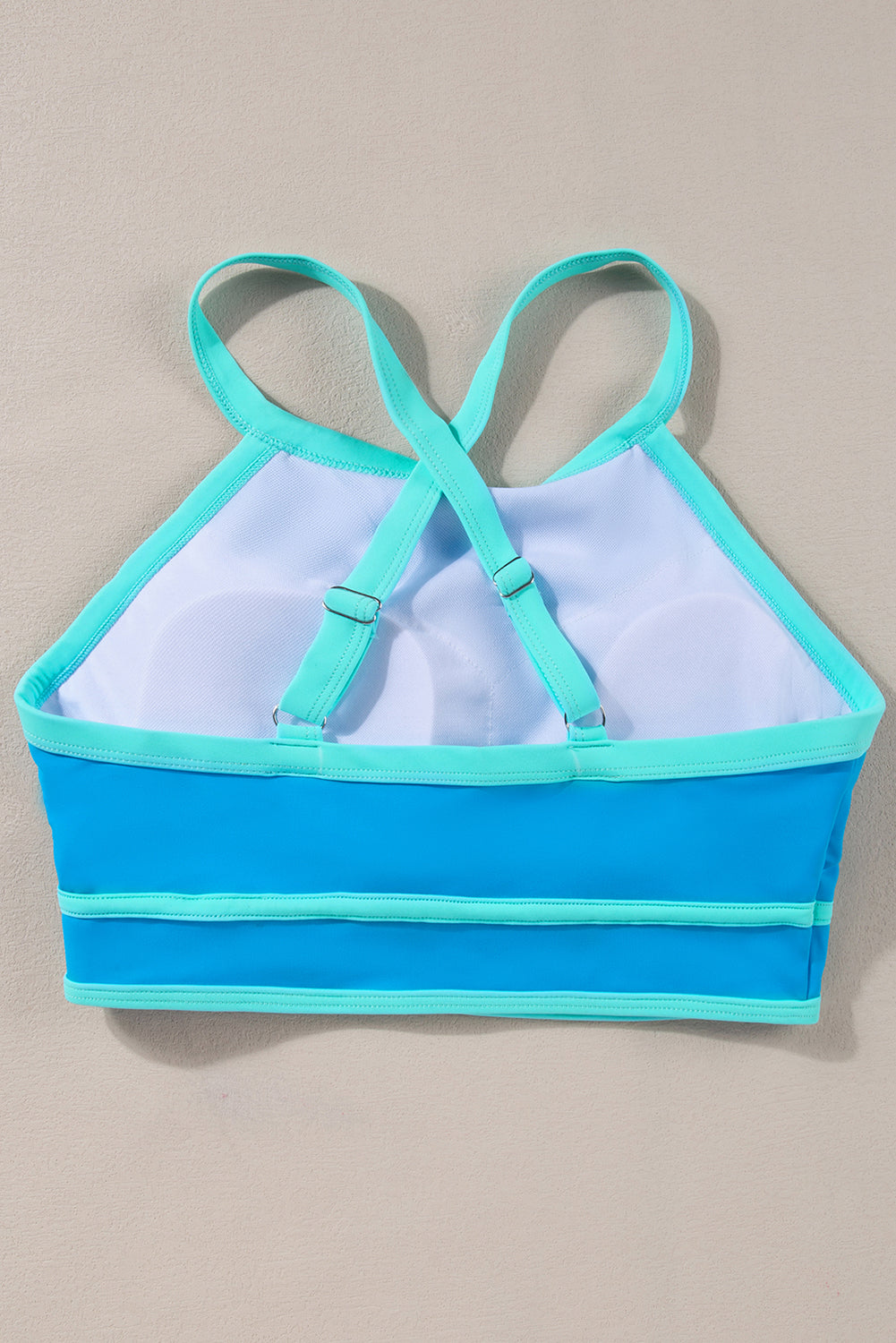 Stylish blue high-waisted bikini with crisscross back design