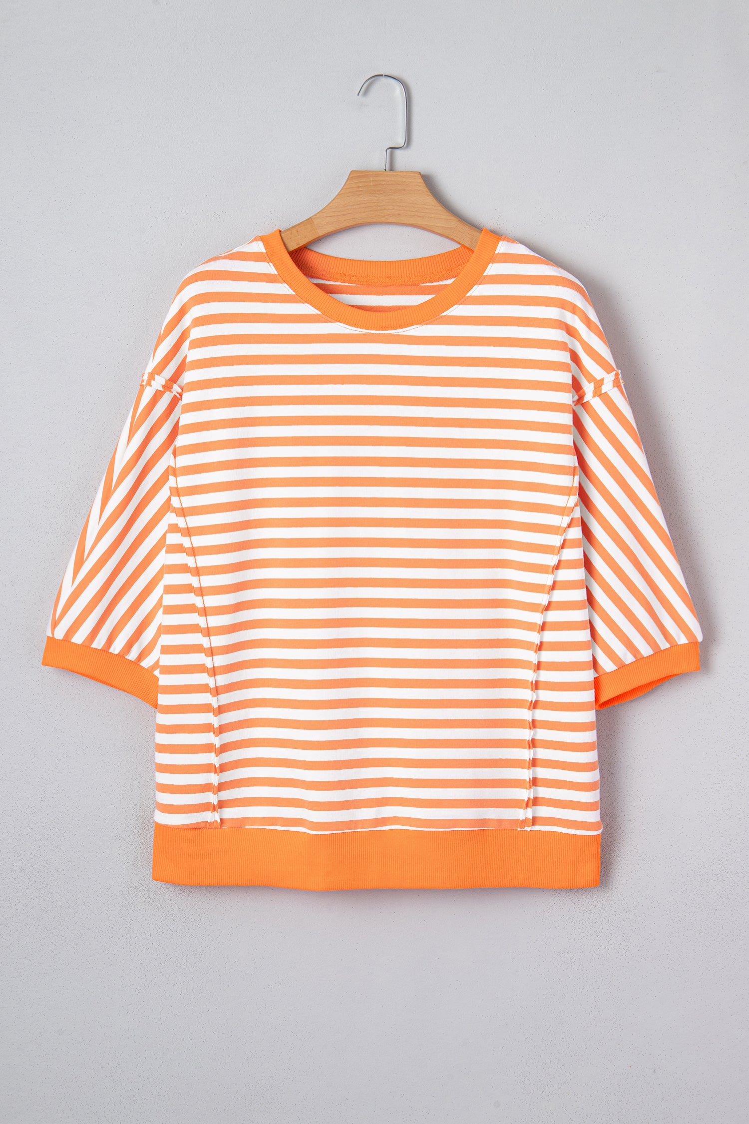 Dear-Lover orange stripe patchwork pullover top with exposed seams and three quarter sleeves