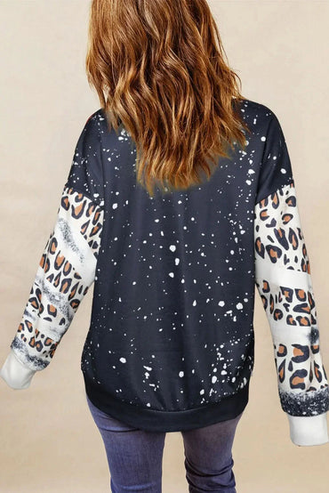 Leopard print round neck long sleeve sweatshirt, black with speckled design.