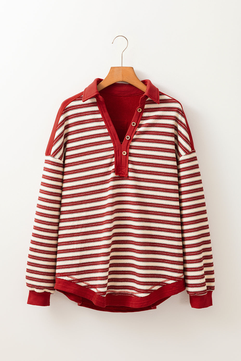 Red Stripe Buttoned V Neck Collared Drop Shoulder Top with long sleeves on hanger.