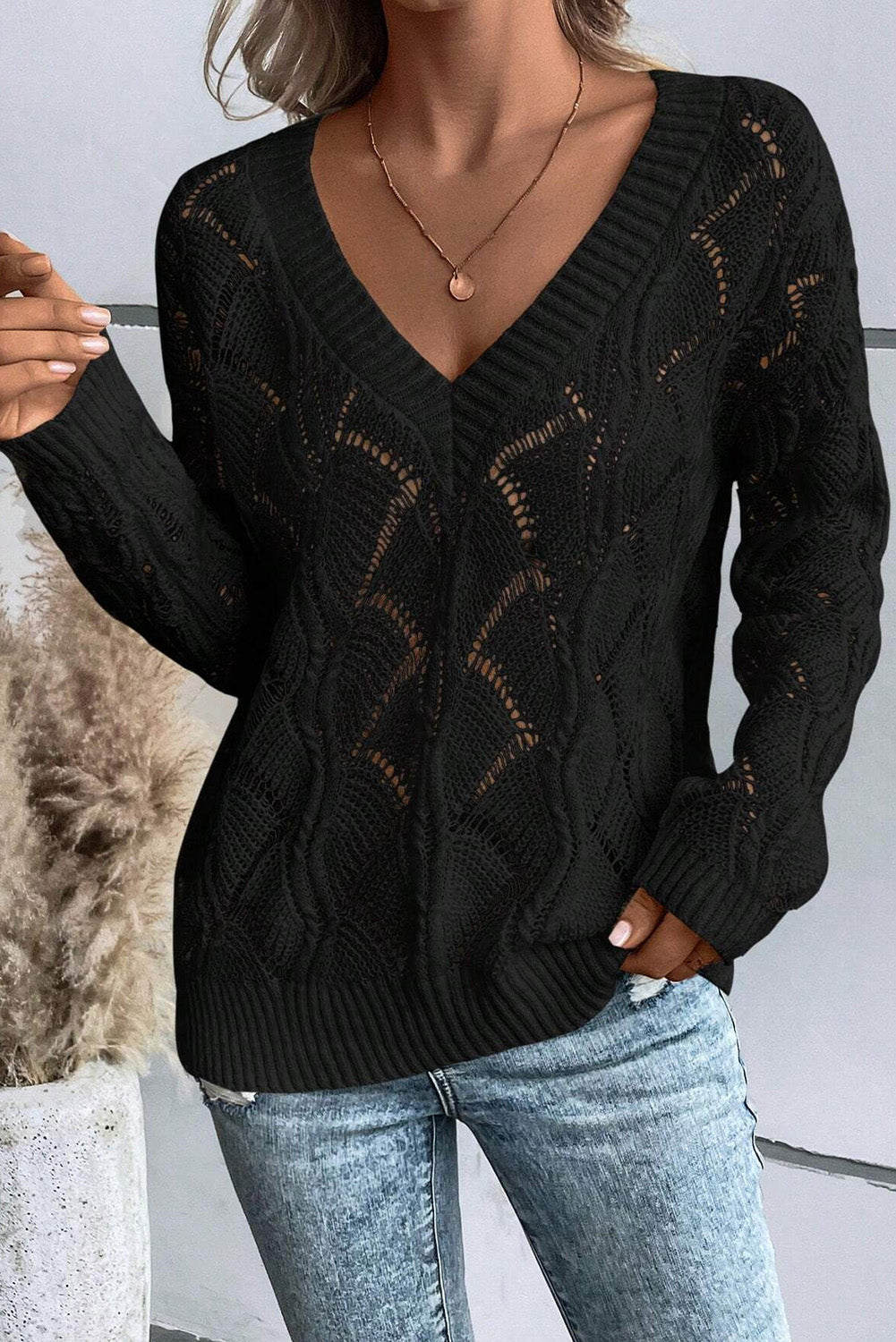 Chic black hollow knit V-neck sweater with drop shoulders