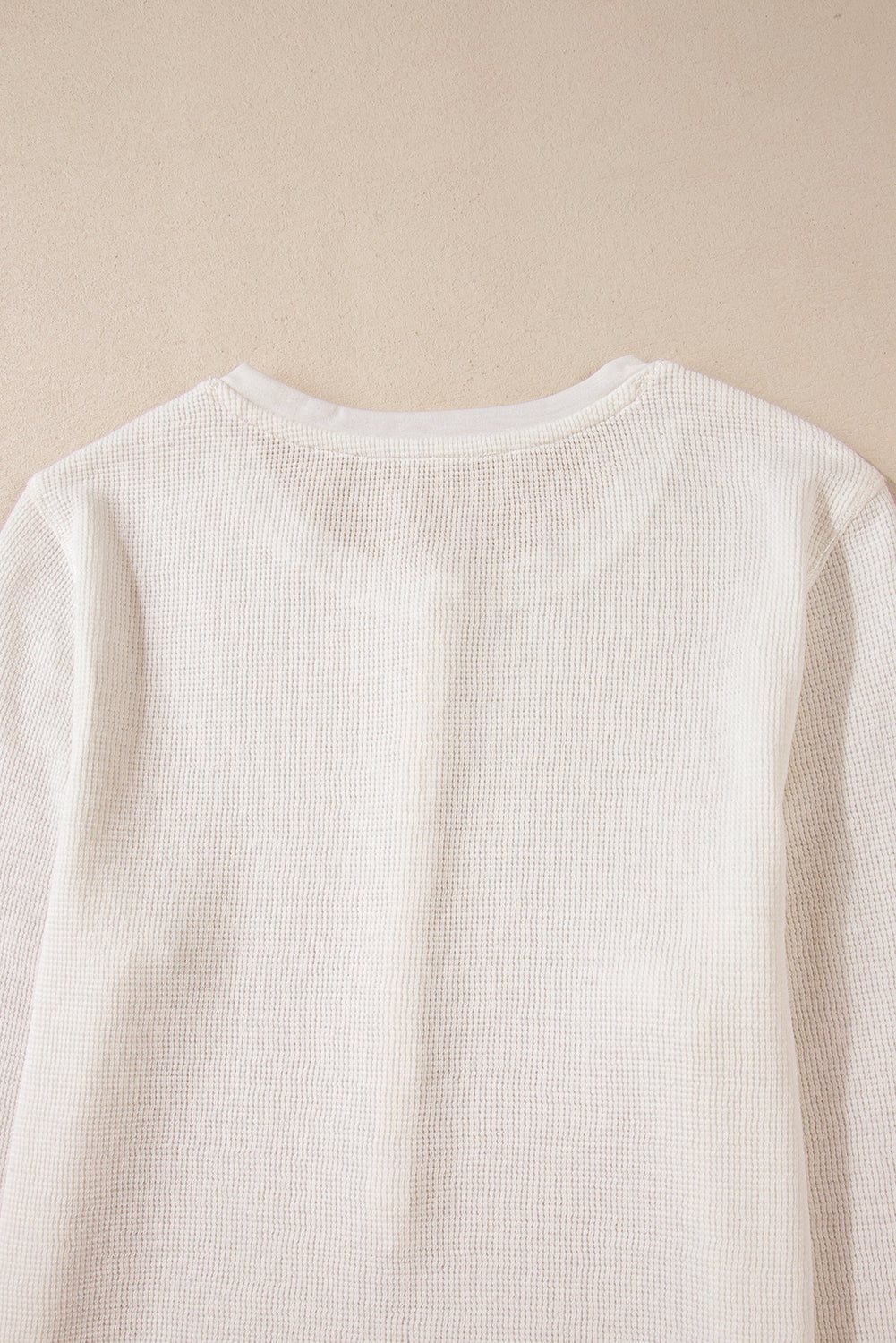 Chic white waffle knit long sleeve top with half button detail