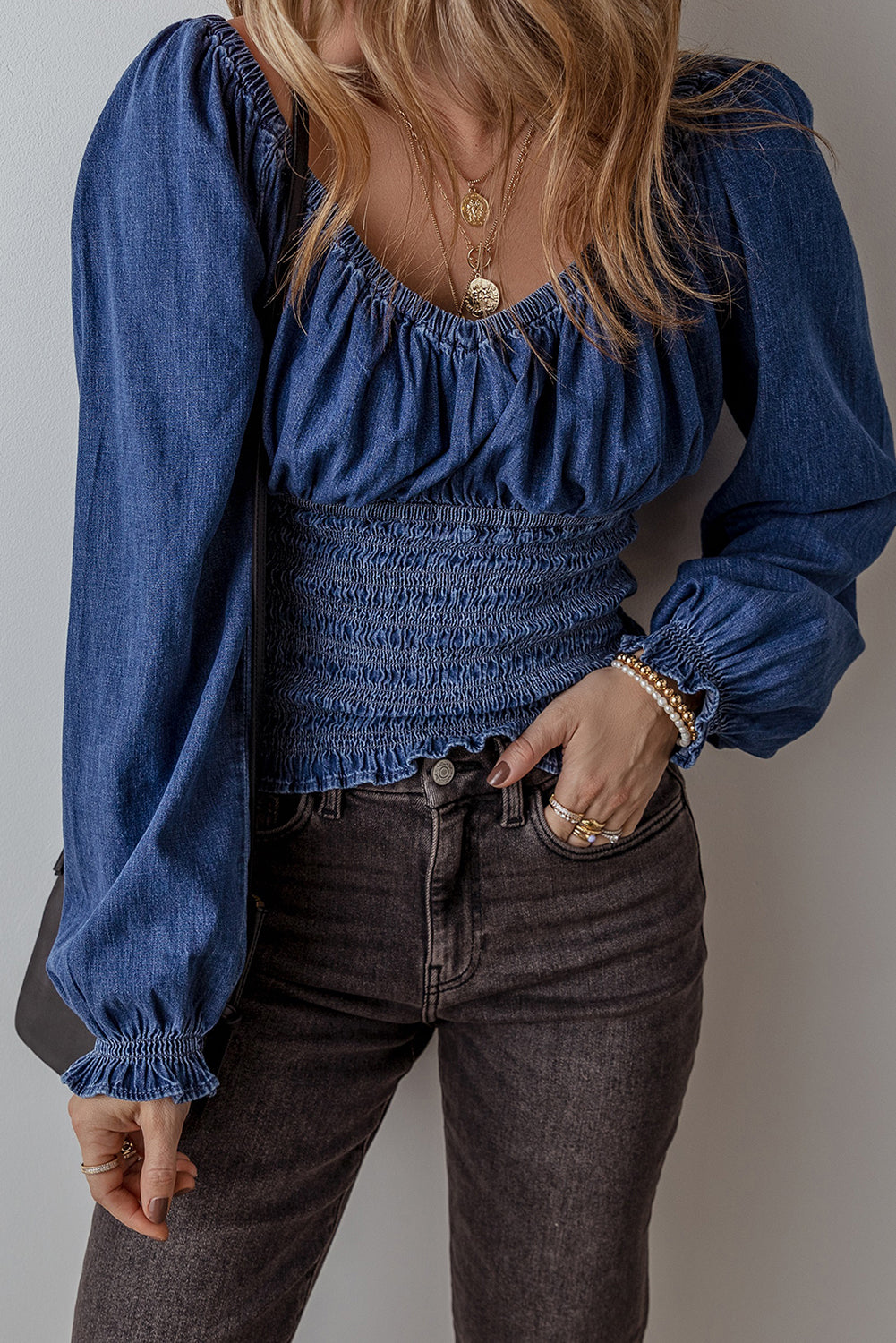 Chic dark blue ruffled puff sleeve denim blouse with smocked details