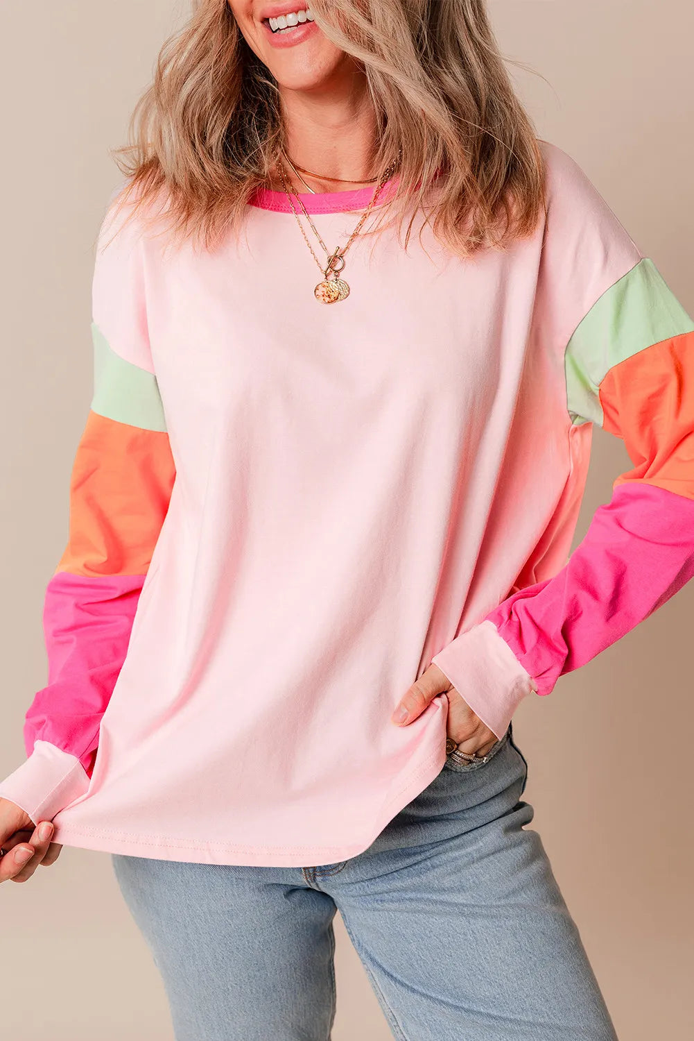 Color block round neck long sleeve top in pink with colorful sleeves, casual style.