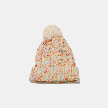 Cozy cable-knit beanie with playful pompom