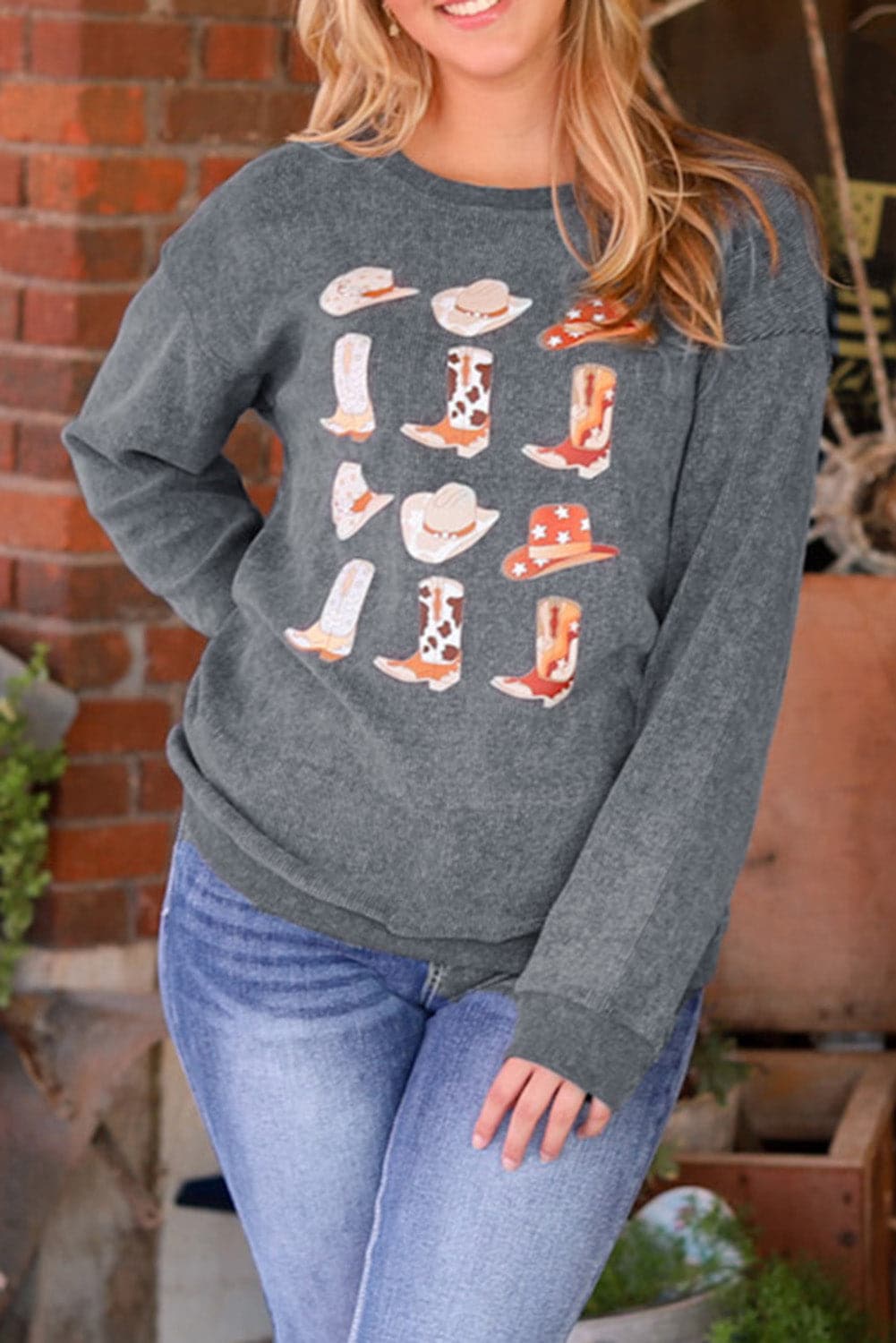 Western flair sweatshirt with cowboy hat and boots graphic