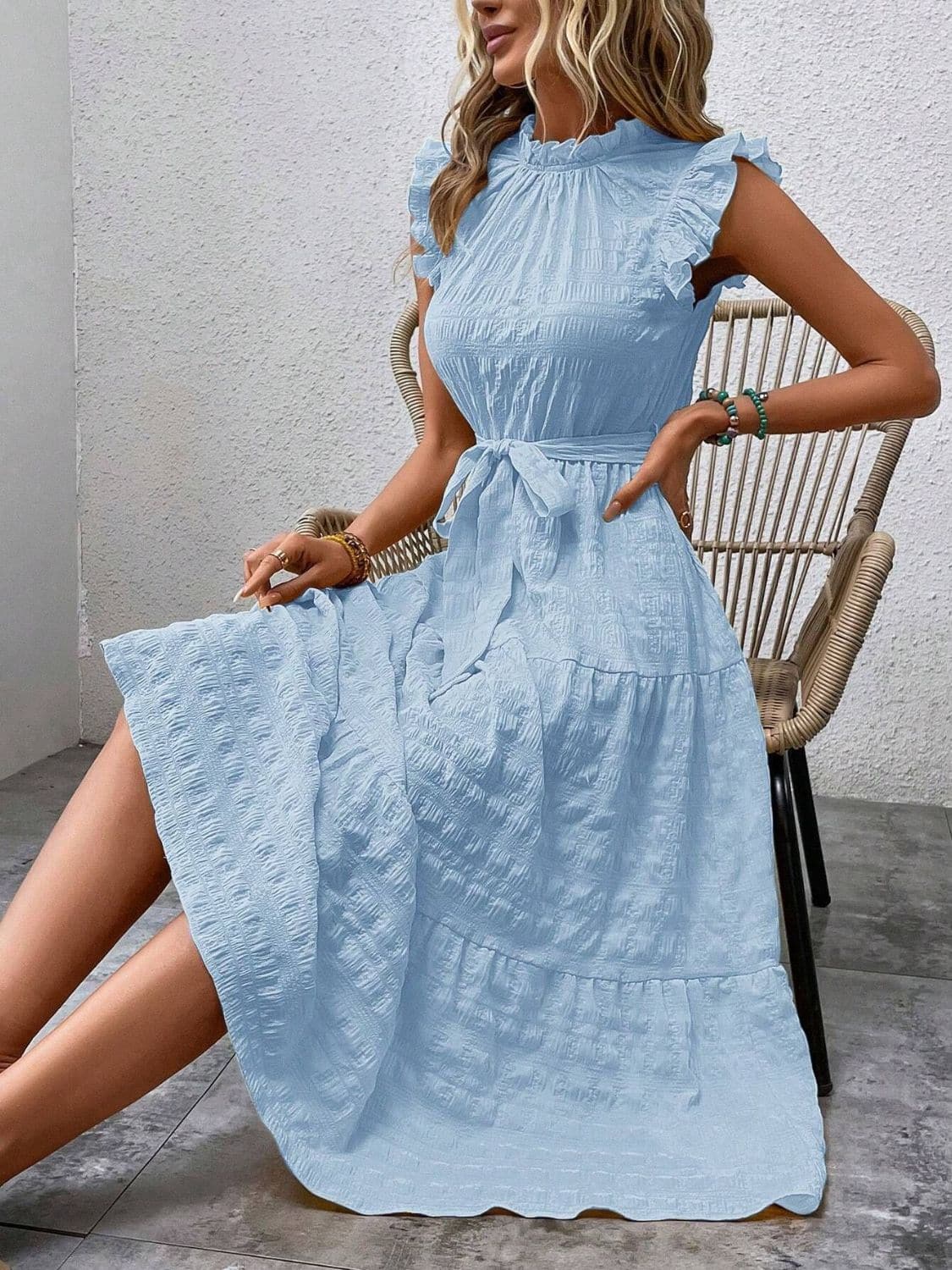 Light blue ruffled cap sleeve midi dress with tied waist detail.