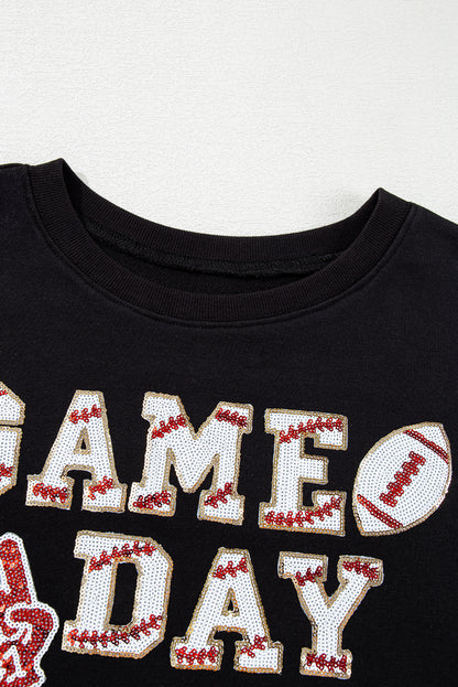 Sparkle on game day with a black cropped rugby sweatshirt featuring tassels and sequins