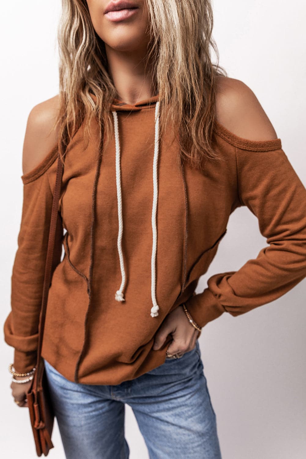 Chic cold shoulder hoodie with long sleeves and drawstring, perfect for casual style.