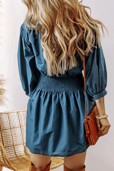 Chic smocked mini dress with half button detail and three-quarter sleeves