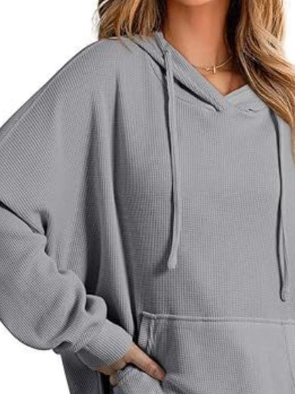 Sleek pocketed hoodie with drawstring and side slit