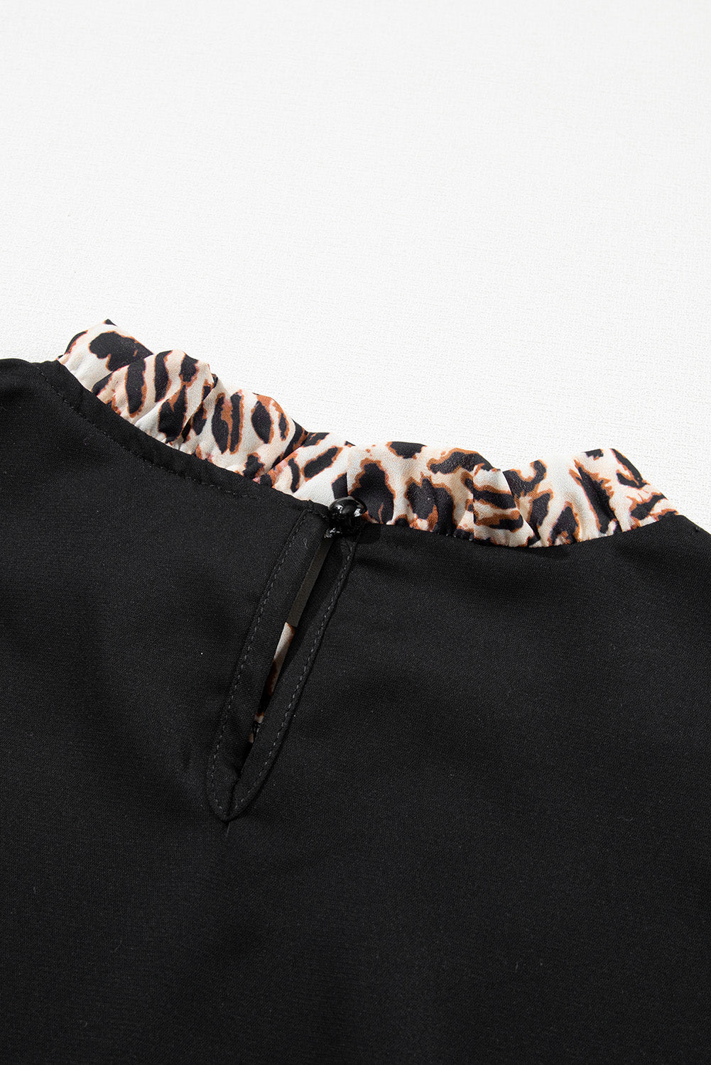 Elegant black lantern sleeve blouse with leopard print accents