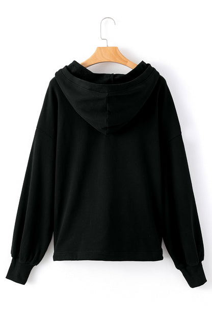 Cozy black oversized hoodie with kangaroo pocket and half zipper