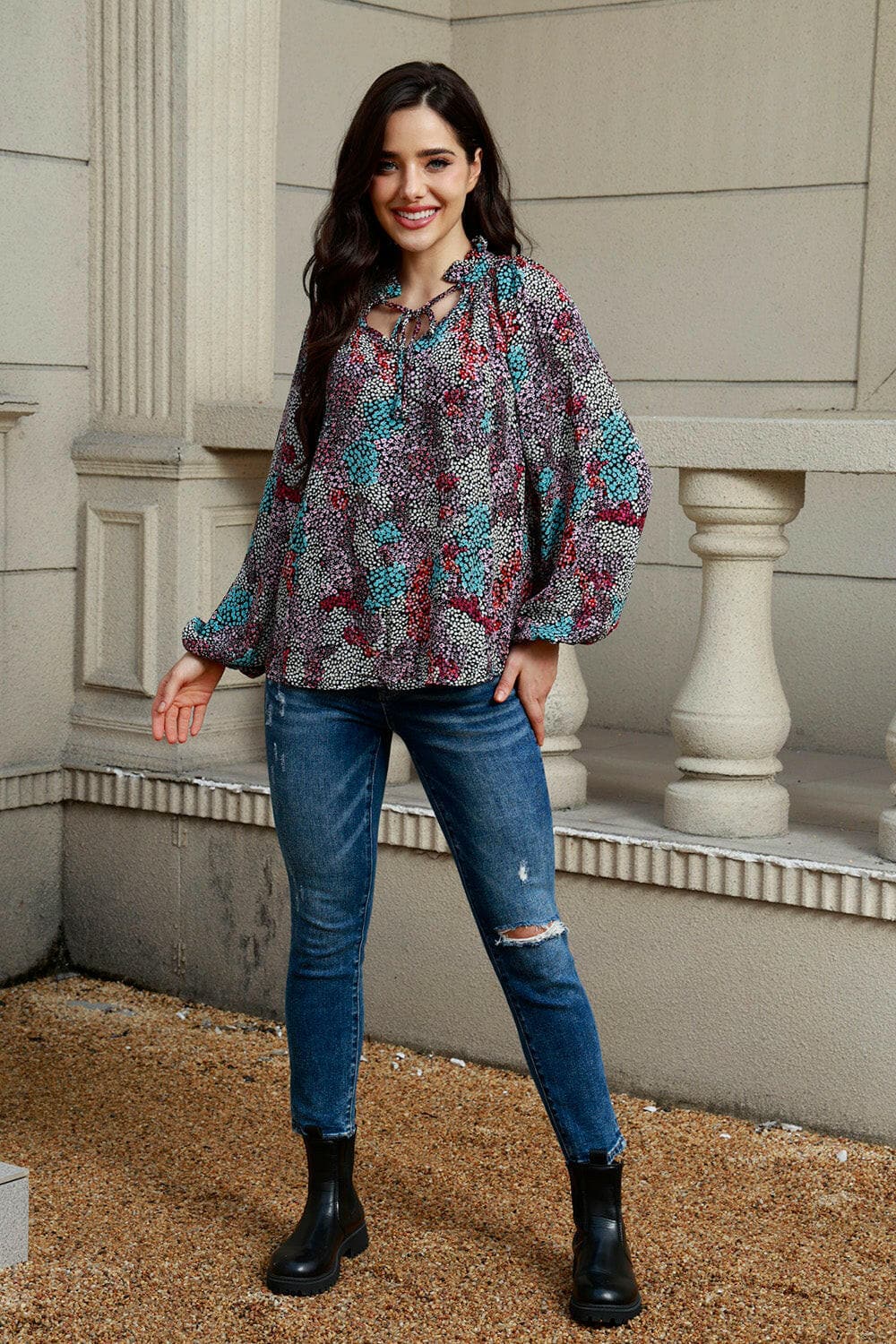 Elegant tie neck blouse with balloon sleeves and floral pattern.