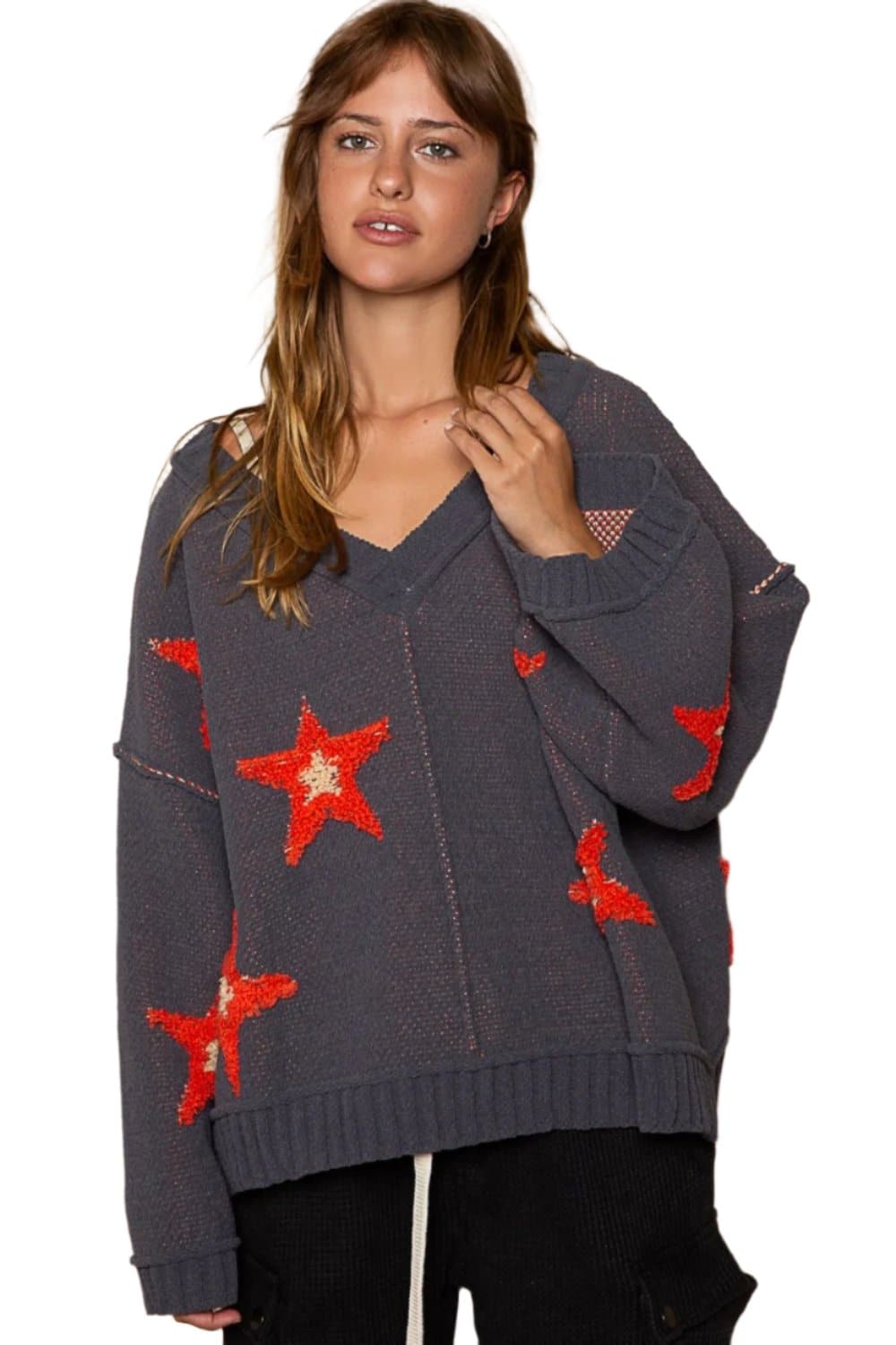 V-neck star patch sweater in cozy fit with color-blocked star design and long sleeves.