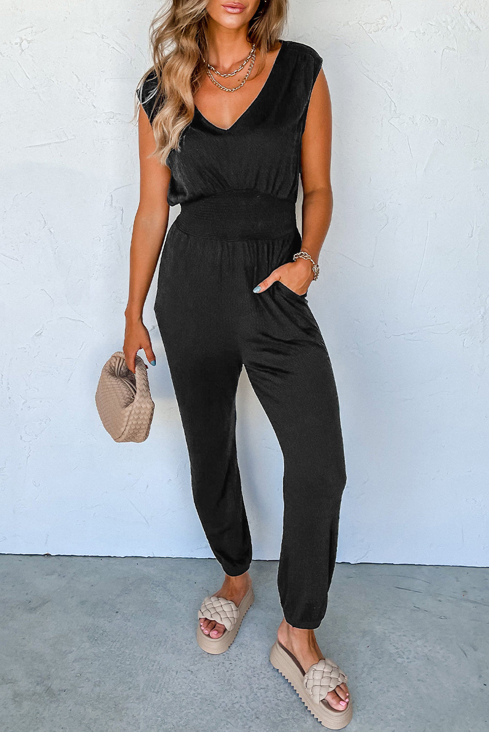 Sleek black sleeveless jumpsuit with v-neck and shirred design