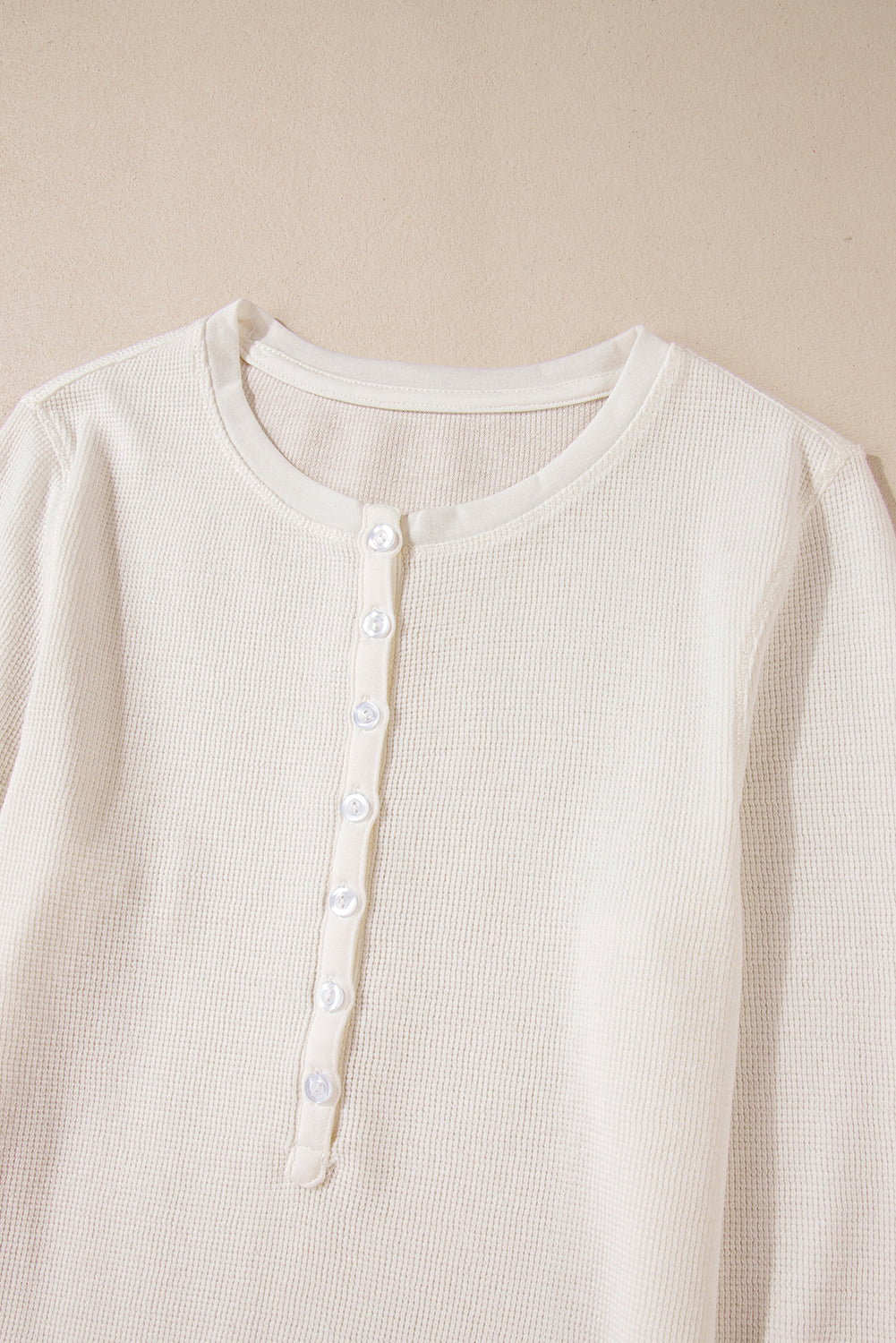 Chic white waffle knit long sleeve top with half button detail