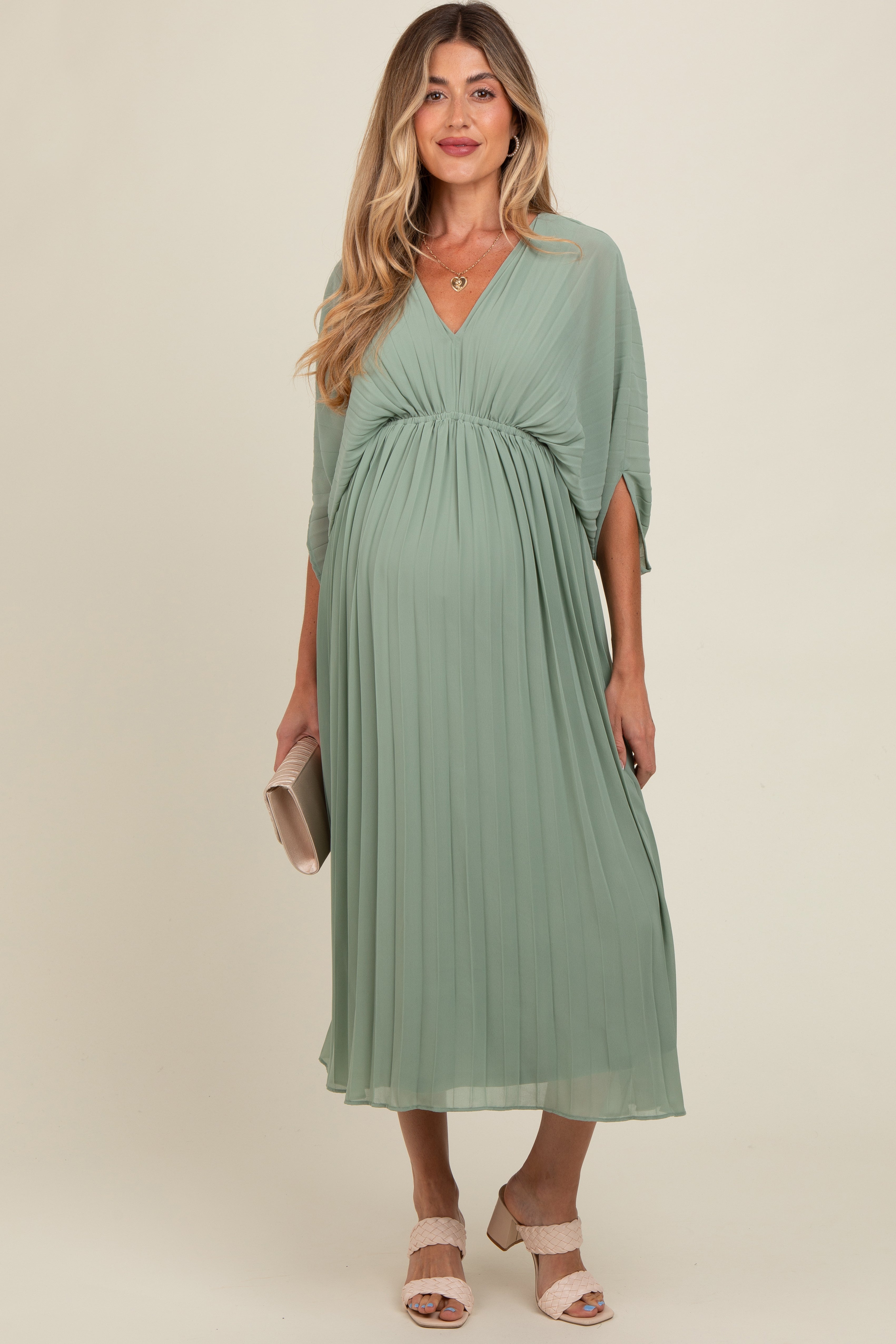 PinkBlush Light Olive Pleated V Neck Maternity Maxi Dress, side profile on model, showcasing the elegant silhouette and drape