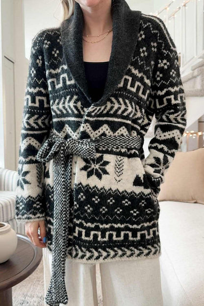 Snowflakes collared neck long sleeve cardigan with belted waist and patterned design.