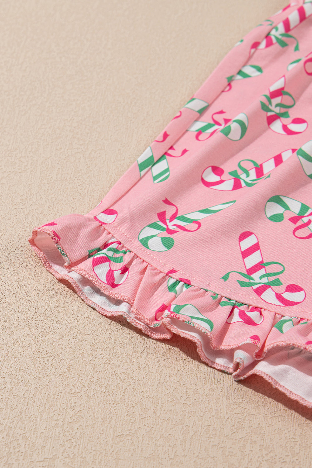 Festive pink candy cane print knotted pajama set with pockets