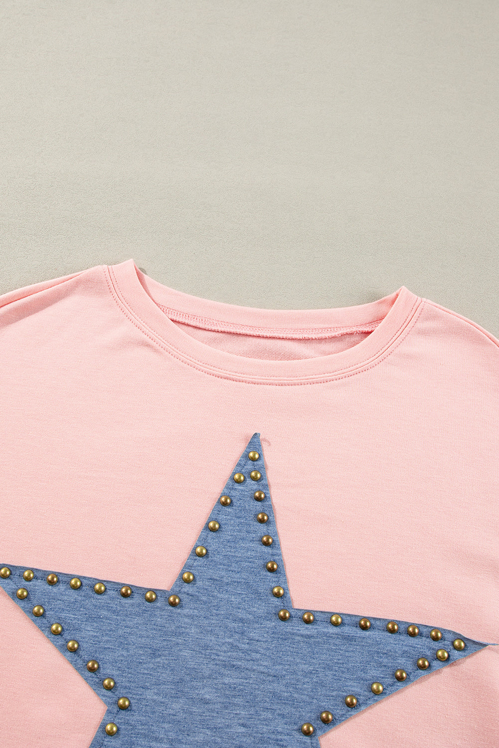 Celestial chic: Gossamer pink oversized long sleeve top with star graphic and studs