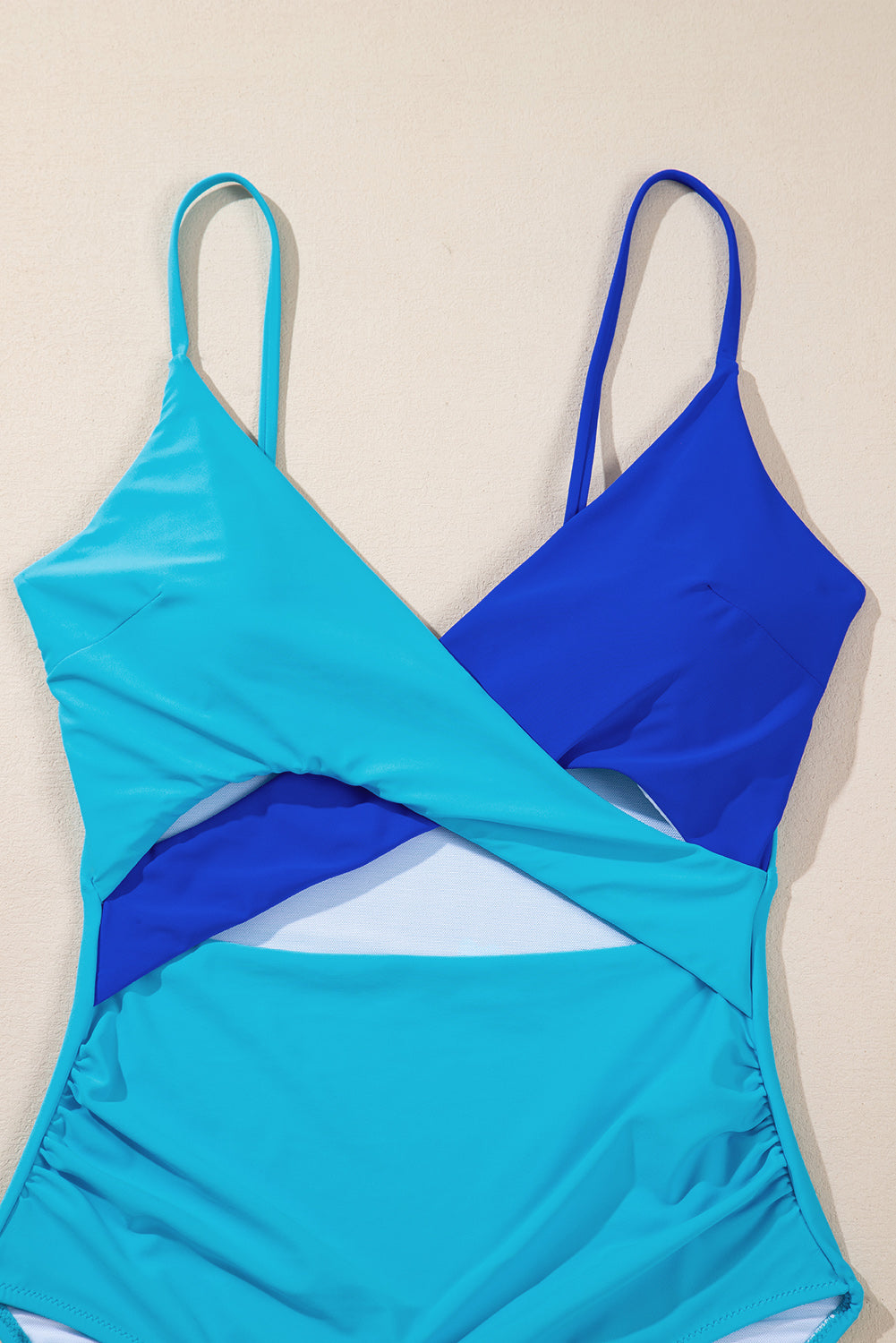 Chic light blue crossover cutout swimsuit with colorblock design