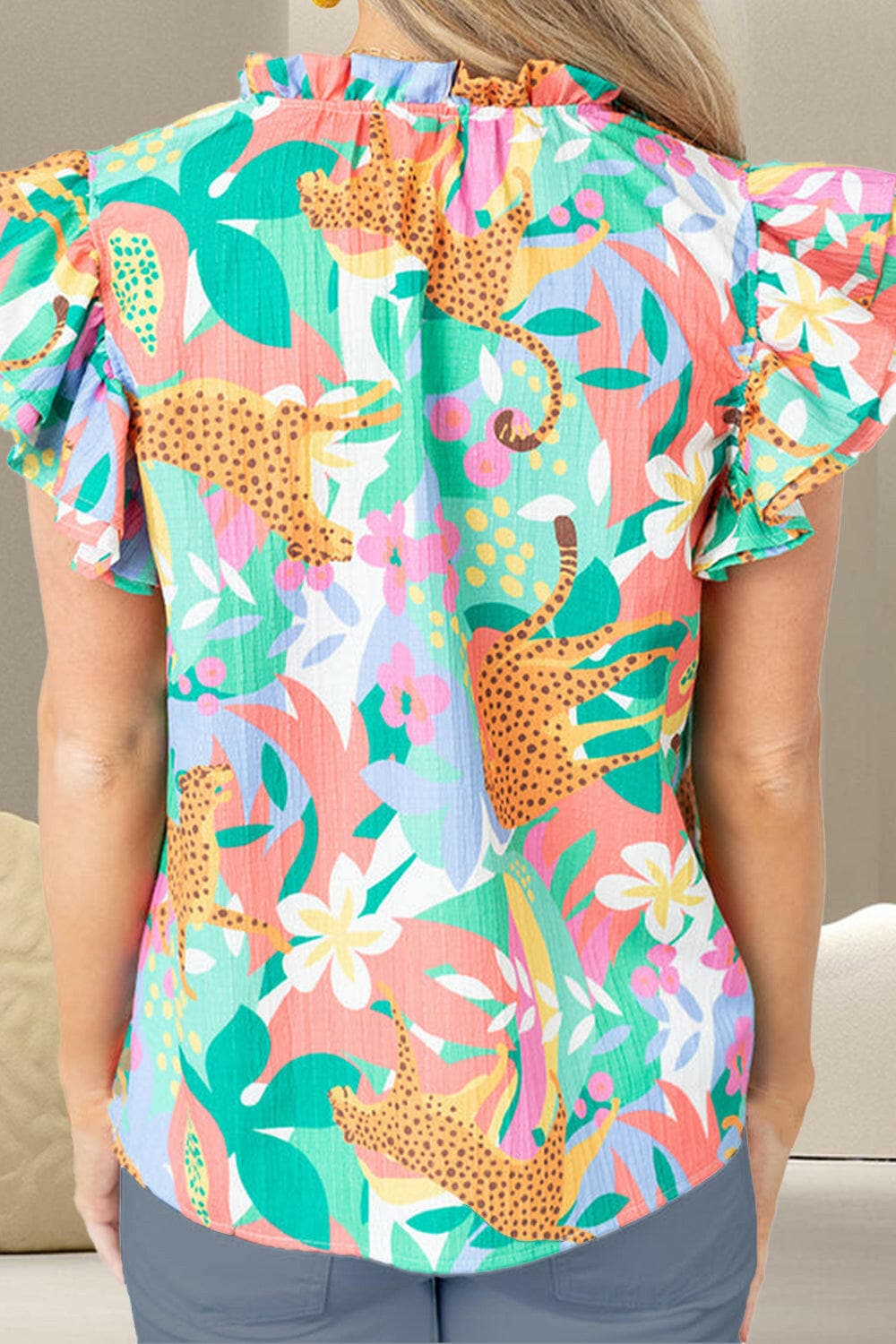 Ruffled Printed Tie Neck Cap Sleeve Blouse.