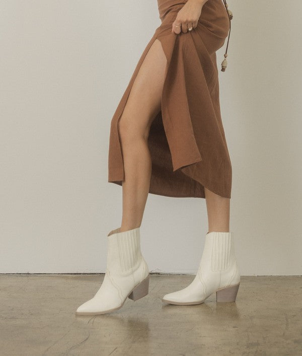 Western-inspired Chelsea bootie with elegant stitch detailing