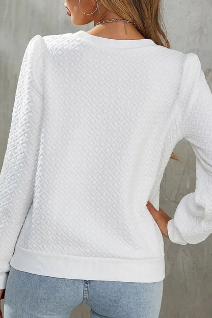 Textured long sleeve round neck top with a flattering fit