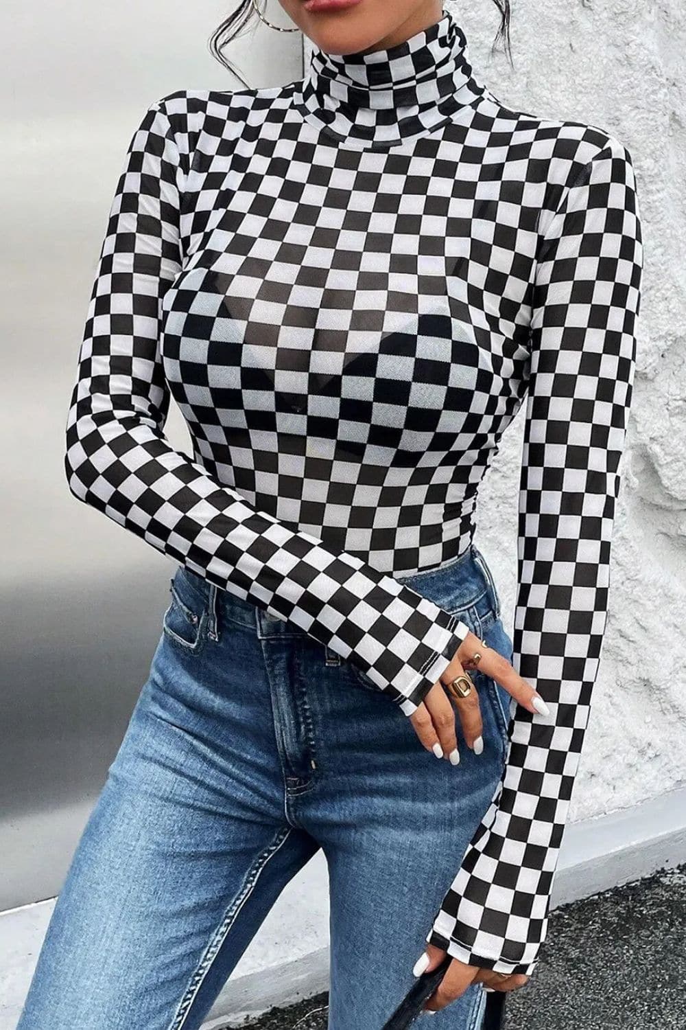 Checkered turtleneck bodysuit on woman with blue jeans