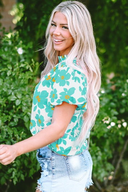 Chic green floral blouse with puff sleeves and frilled neckline