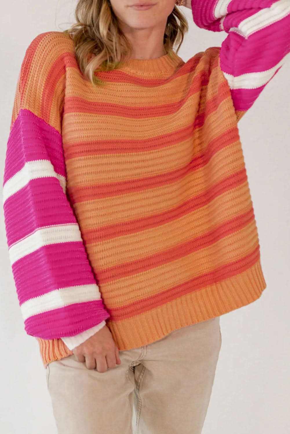 Striped Round Neck Long Sleeve Sweater with vibrant orange and pink stripes.