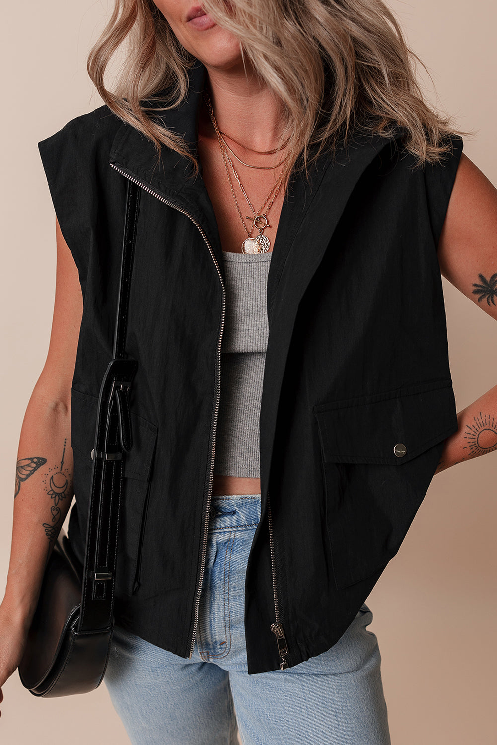 Chic black high neck vest with zip-up front and flap pockets