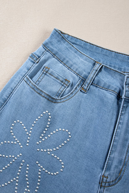 Light blue high-rise wide leg jeans with floral rhinestone embellishments