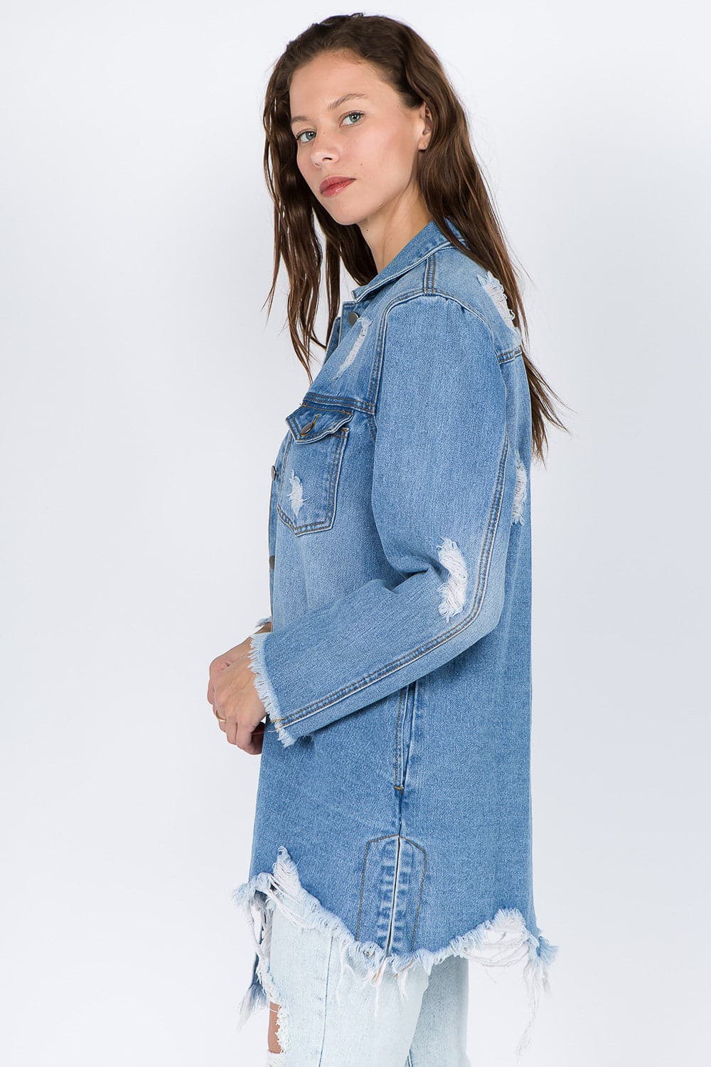 Distressed denim jacket with frayed hem for a vintage vibe