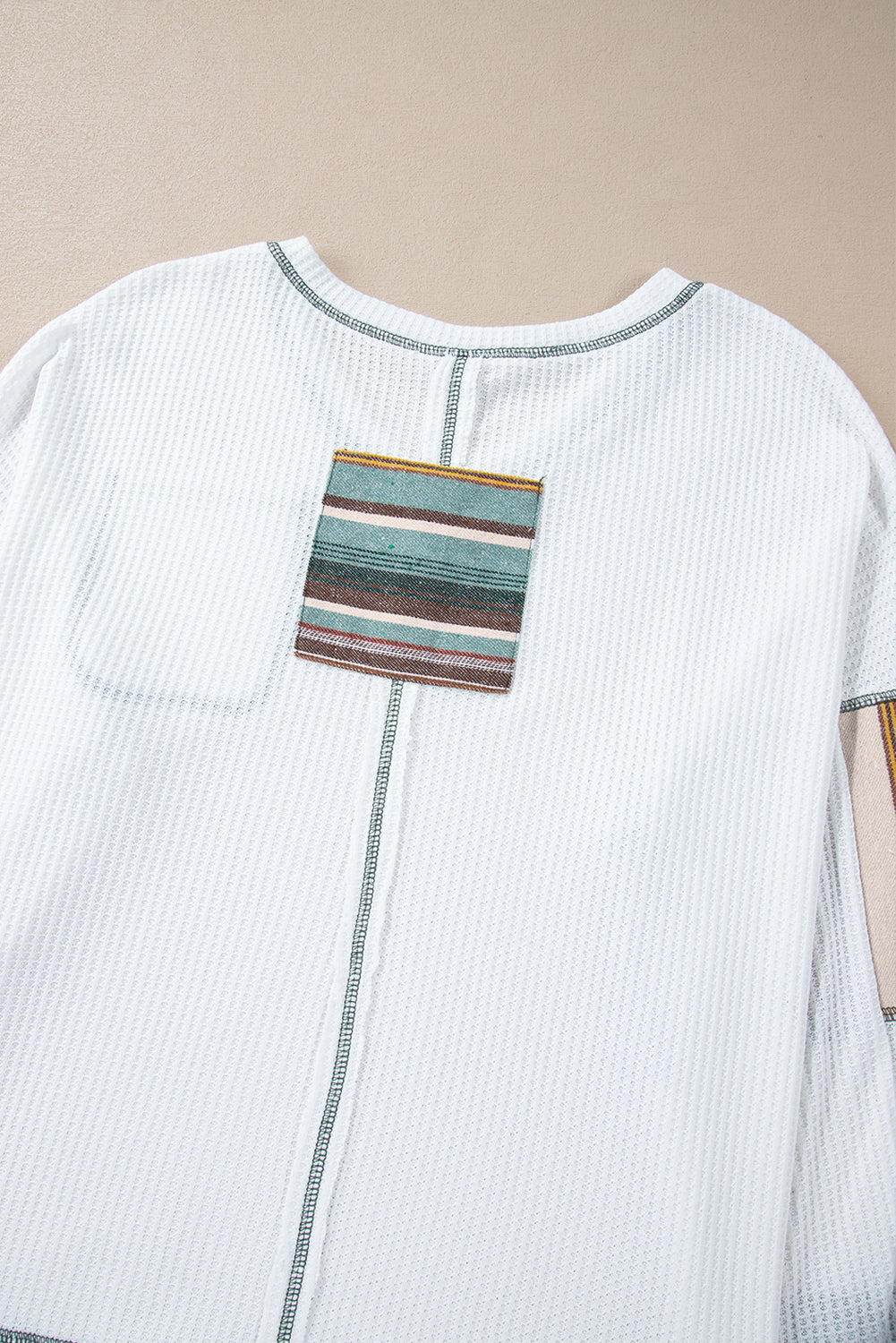 Chic white striped patchwork waffle knit top with exposed seams