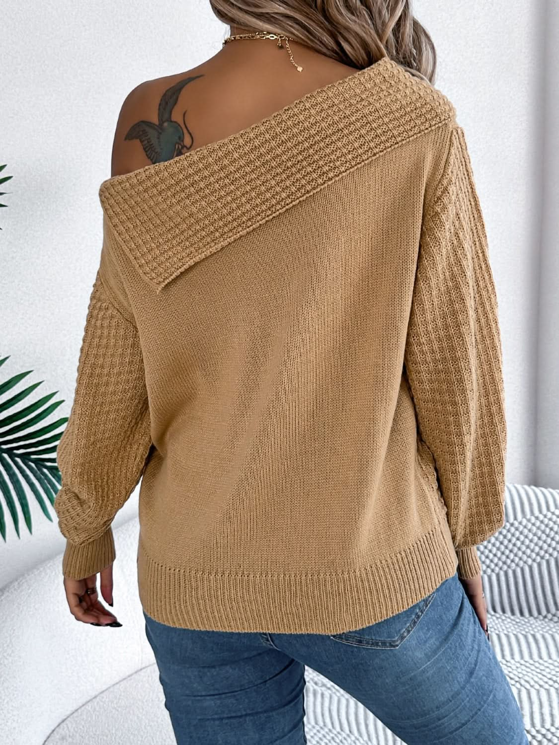 Asymmetrical cable-knit long sleeve sweater