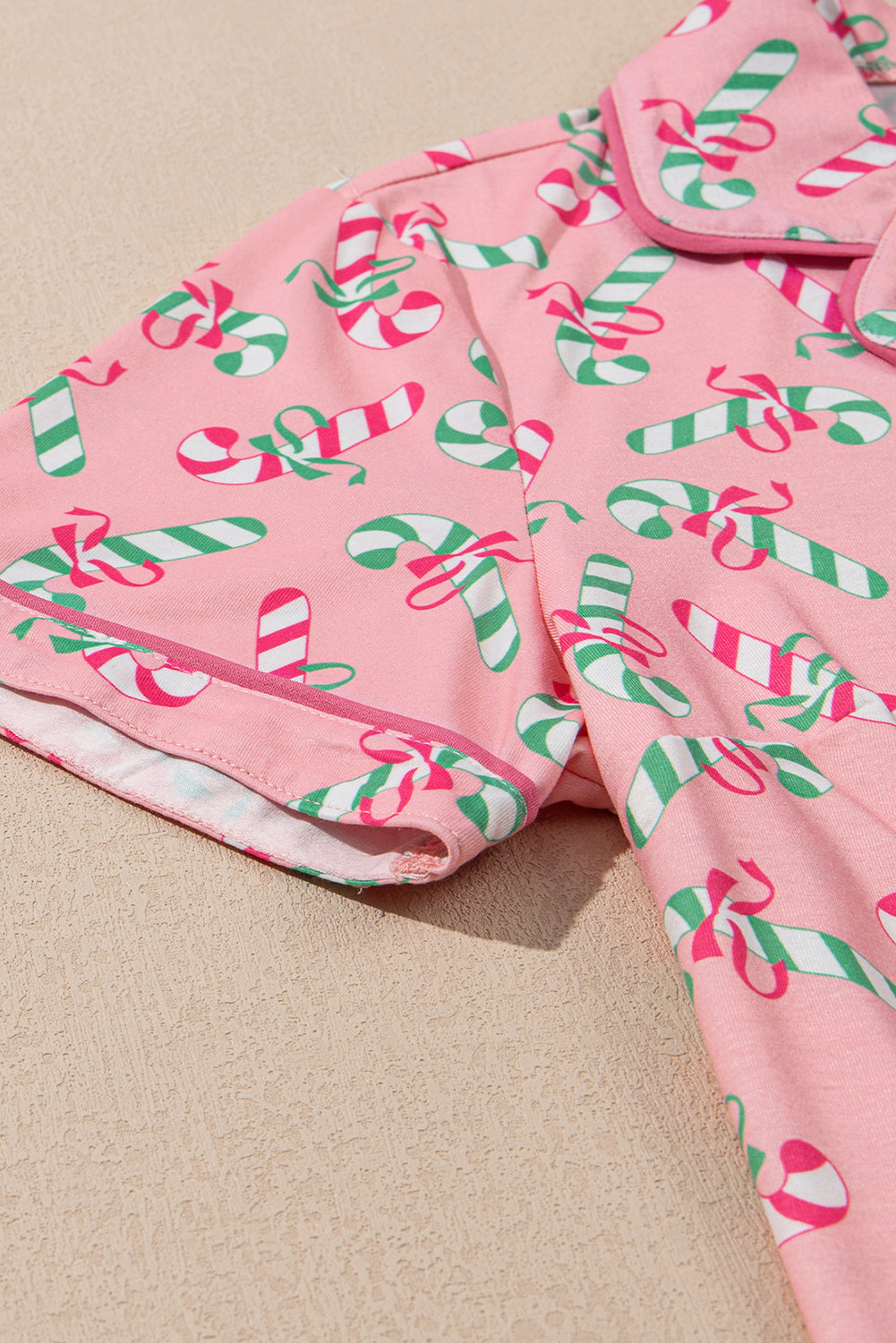 Festive pink candy cane print knotted pajama set with pockets