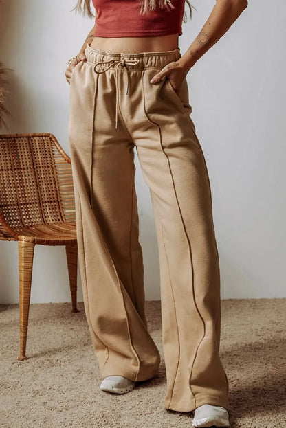 Wide leg drawstring trousers with pockets in beige, premium polyester-cotton blend.