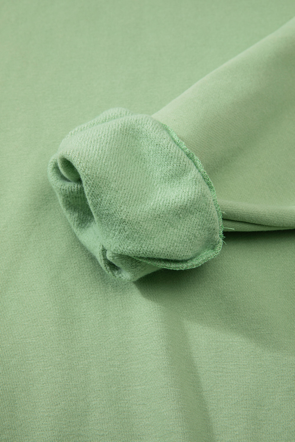 Cozy smoke green fleece-lined sweatshirt with drop shoulder design