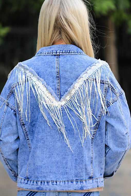 Close-up of the Miss Sparkling denim jacket fringe. Shows texture and detail of the denim.